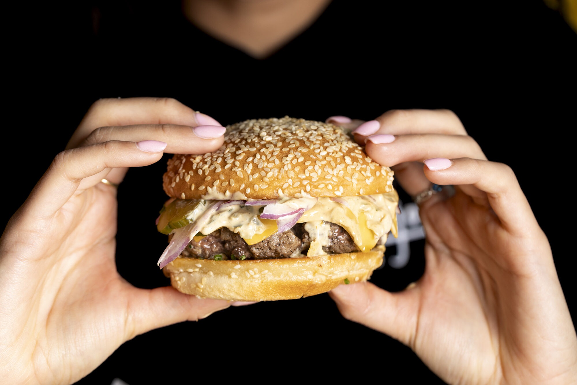 Cheeseburger held in two hands